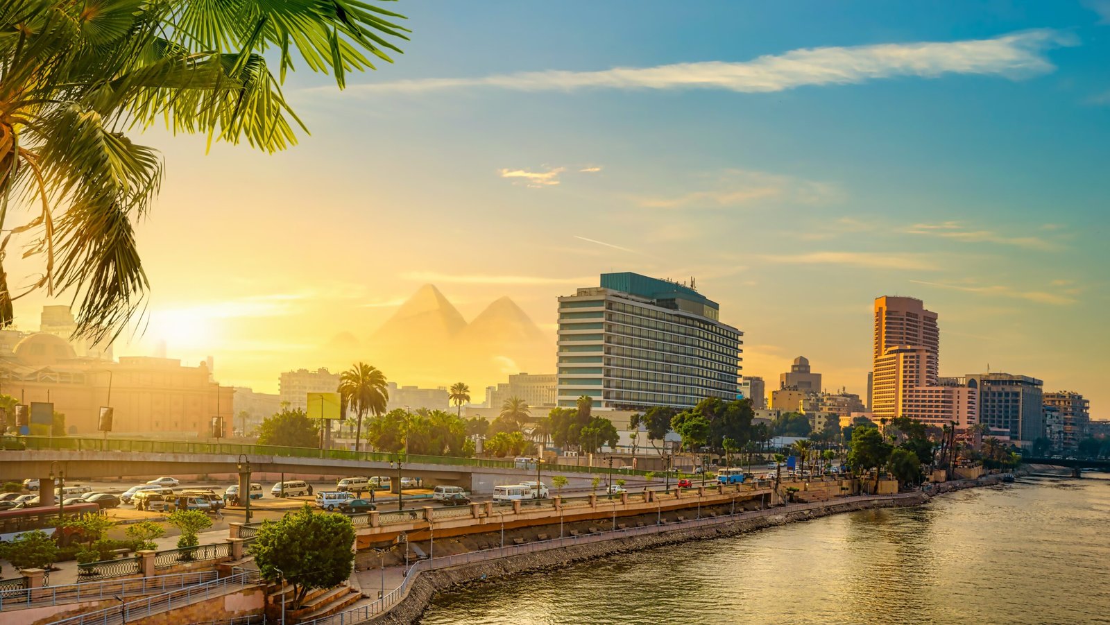 View of from Nile River modern Cairo with pyramids in backdrop