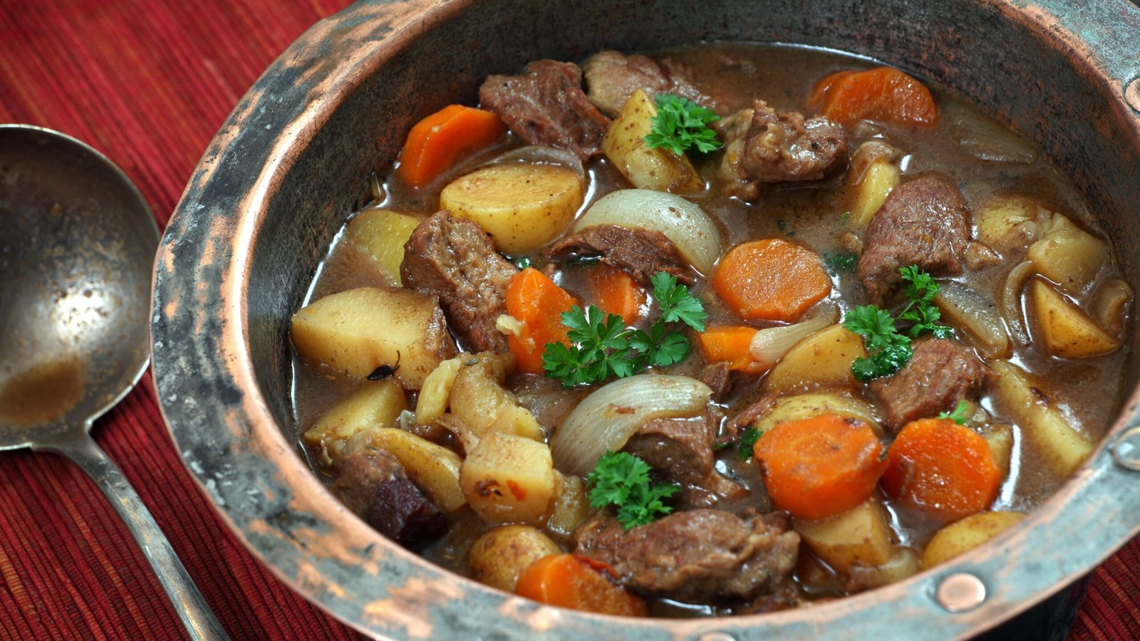 Irish stew or Guinness stew made in old copper pot