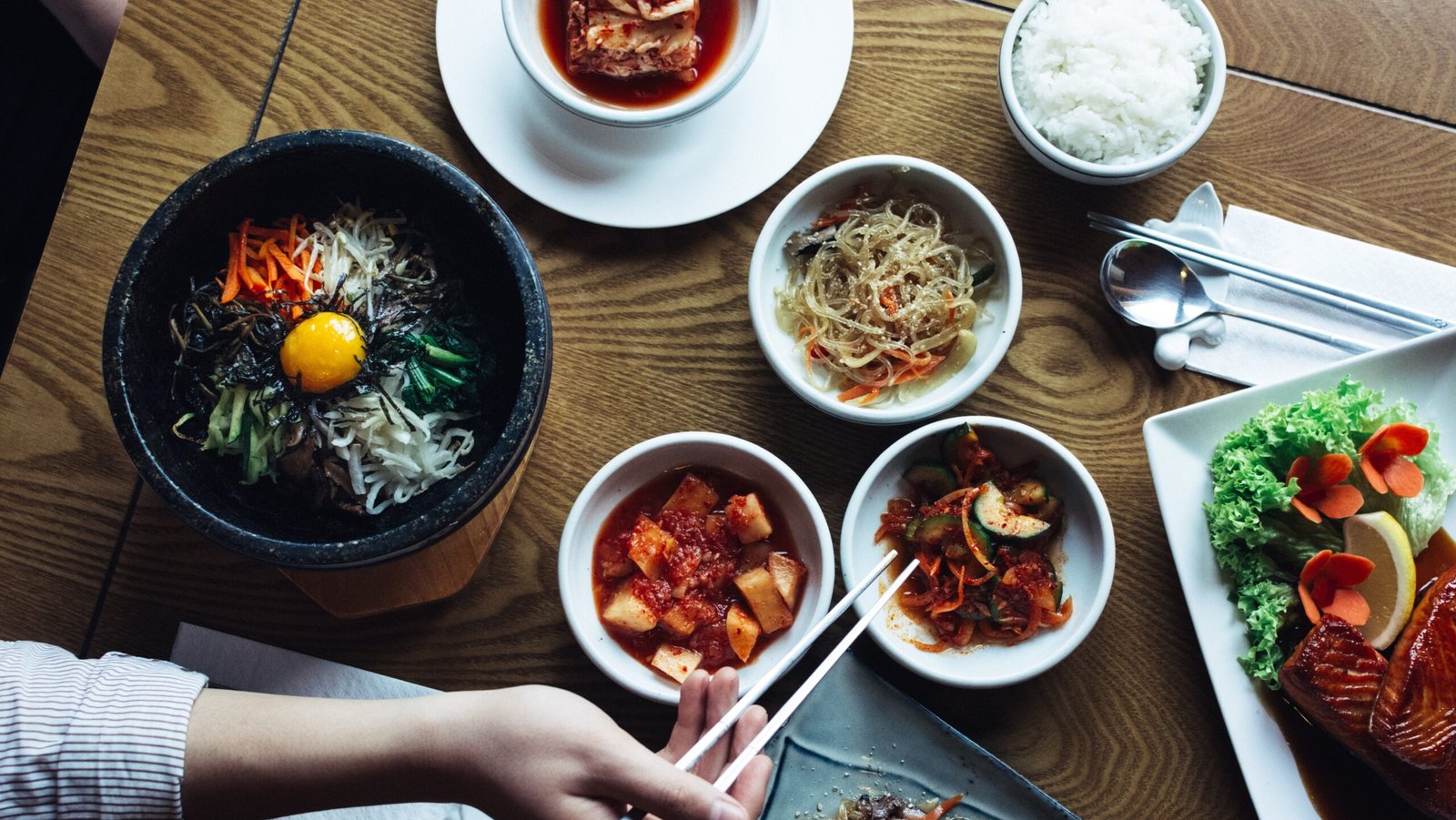 A person is eating Korean foods in the restaurant